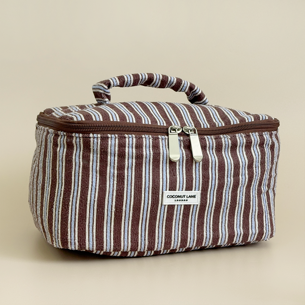 Brown, white and blue striped Vanity Case with silver zip and padded handle.