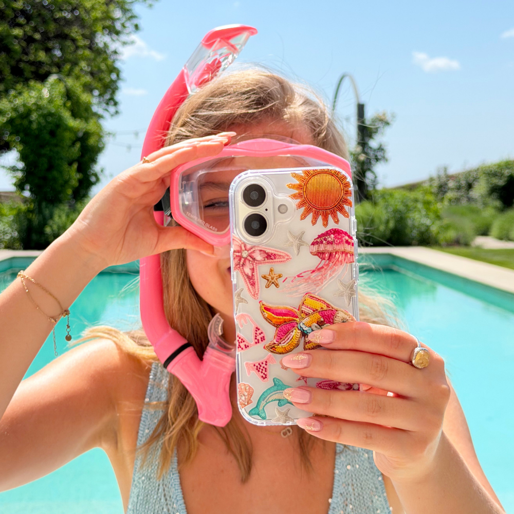 Girl with snorkle in pool holding Pink Paradise Phone Case