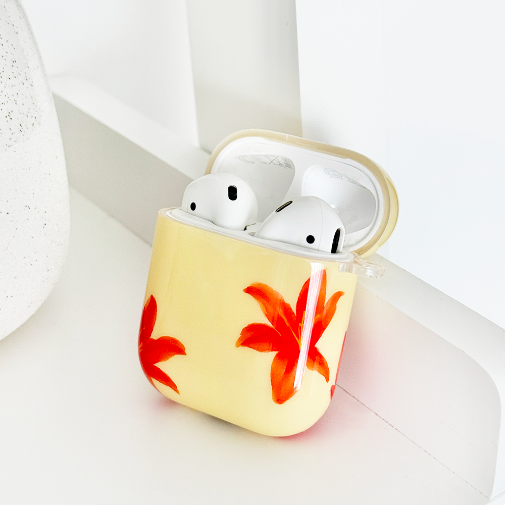 Red-orange floral print AirPods case with a glossy finish from Coconut Lane.