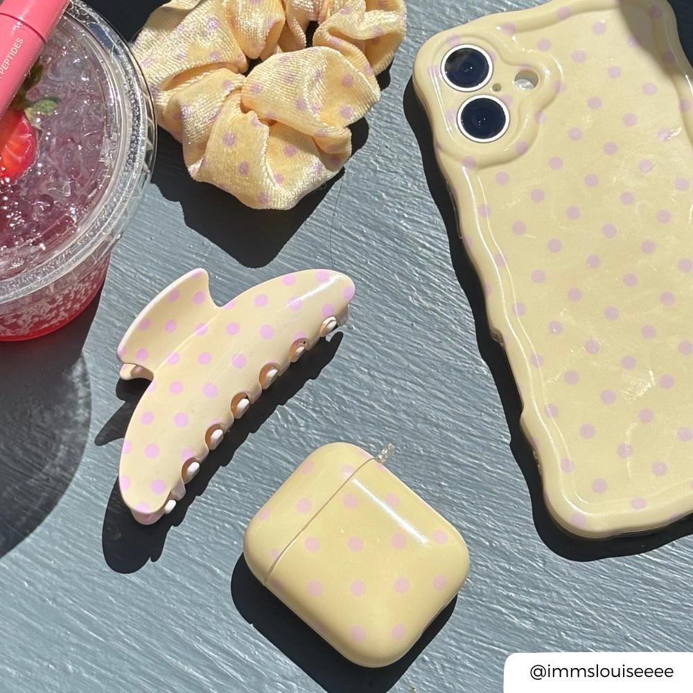 AirPods Case in Butter Blush next to matching accessories