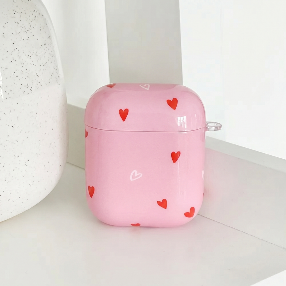 Pink AirPods Case with red and white heart design. 