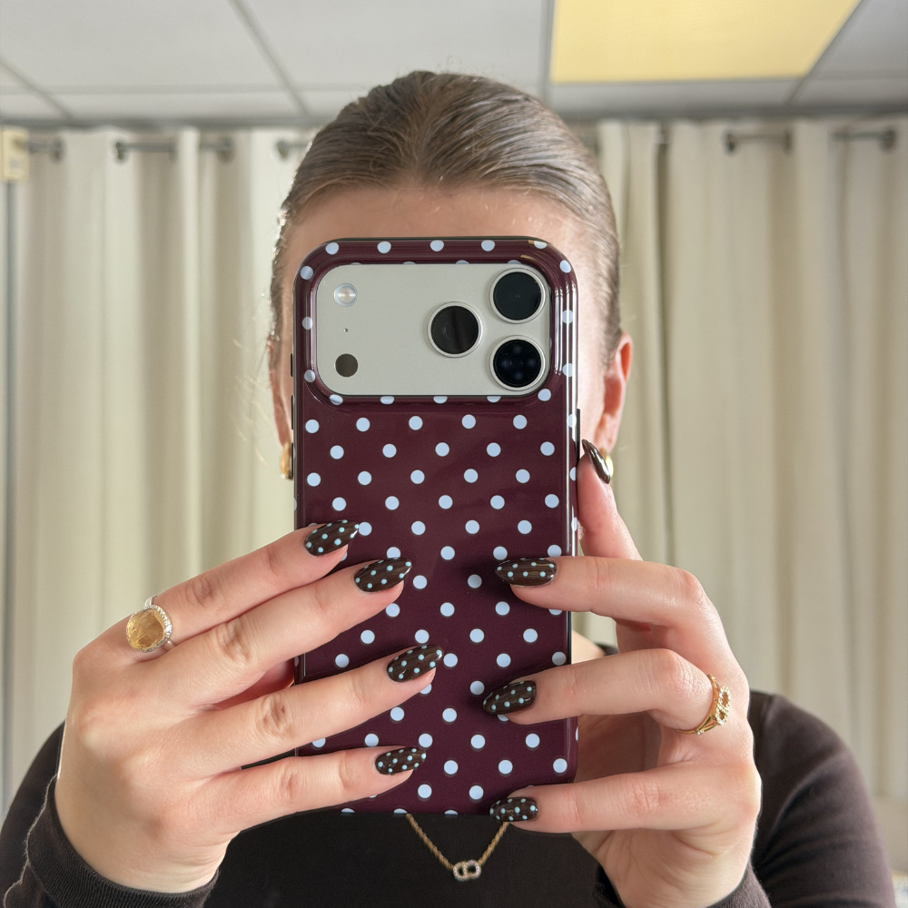 Girl with matching brown polka dot nails to the brown and blue polka dot tough phone case