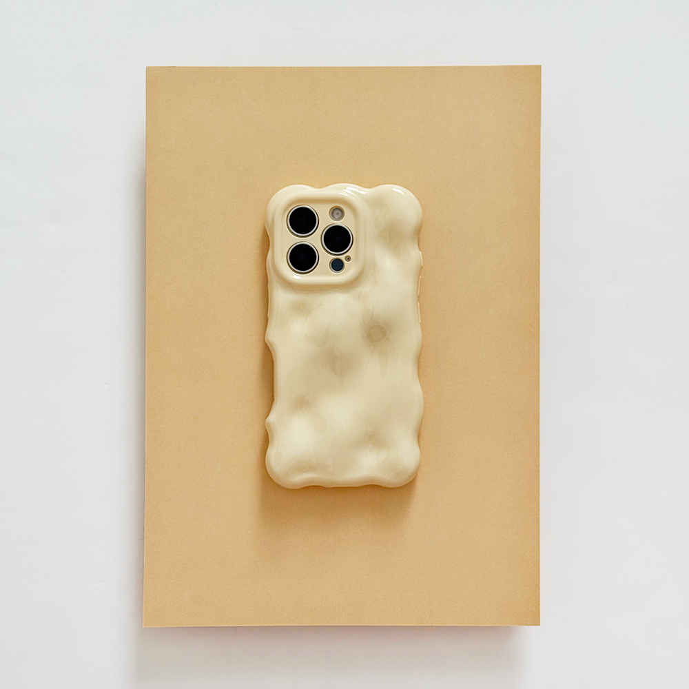 Butter yellow 3D bubble phone case by Coconut Lane on a brown surface with a white background.