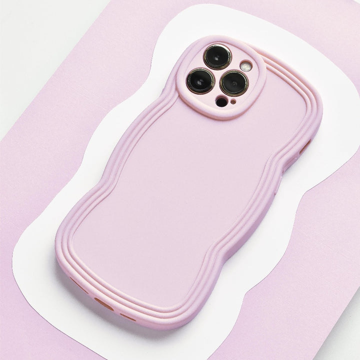 A NAKD Curvy Phone Case - Blueberry by Coconut Lane with a wavy, textured design is shown from the back. The lightweight case has precise cutouts for the camera lenses and buttons. The background features a light pink and white abstract pattern.