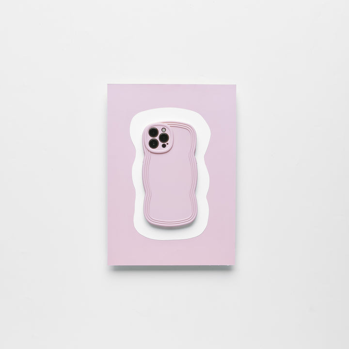 A smartphone with a Blueberry protective case from Coconut Lane lies on top of a light pink and white wavy-edged mat against a plain white background. The lightweight NAKD Curvy Phone Case highlights the phone camera cutout, making it both stylish and functional.