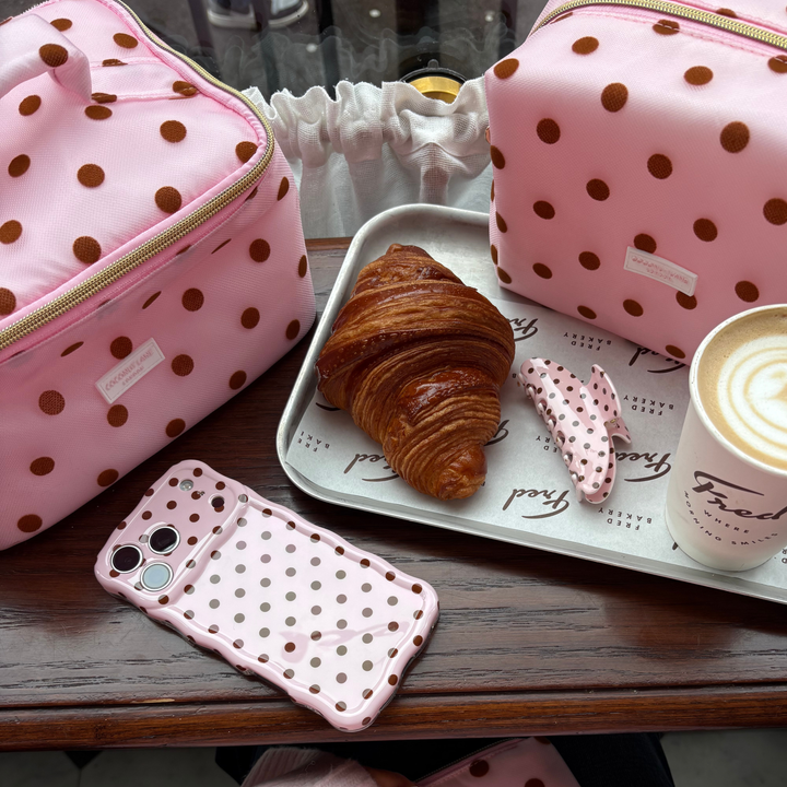 Dot Society Pink and Brown makeup bag with matching claw clip, wavy phone case and vanity case. Makeup bag is a sheer mesh pink material with brown polka dot detailing.