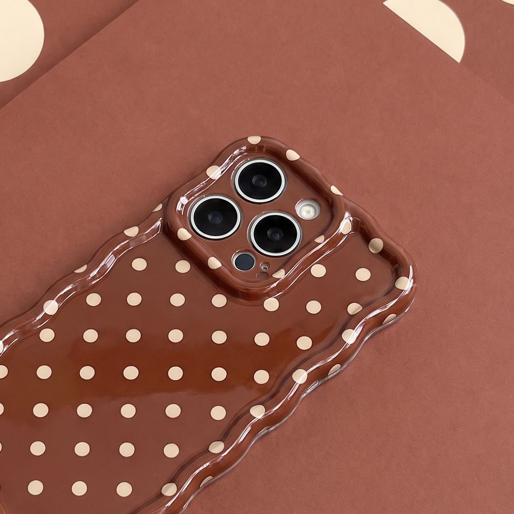 Glossy brown phone case with small cream polka dots and a wavy edge.
