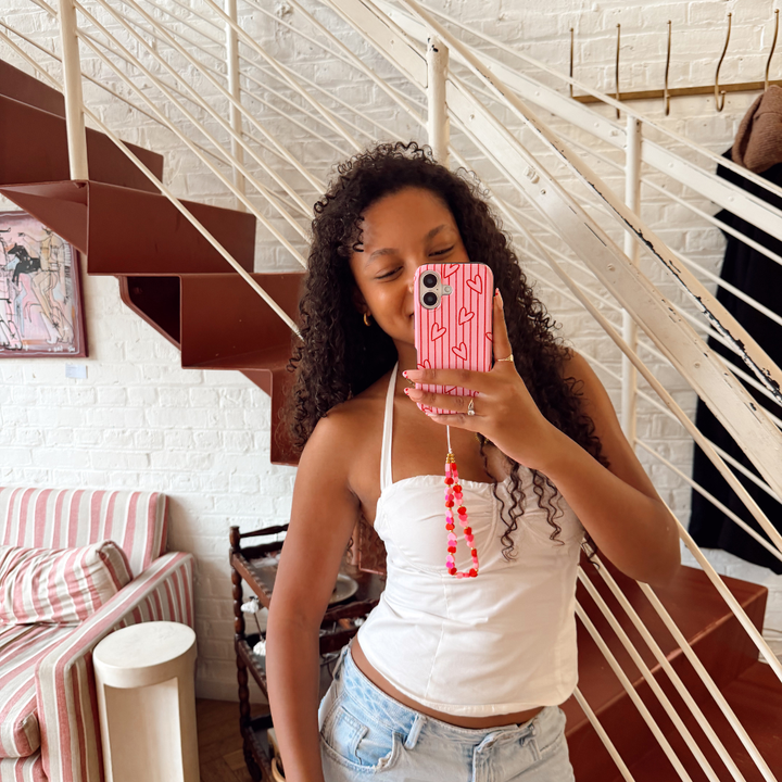Girl with pink phone case and hearts phone strap