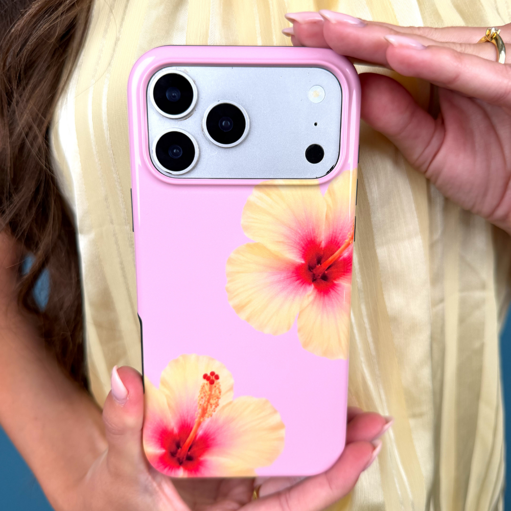 Phone case with floral design held by a person