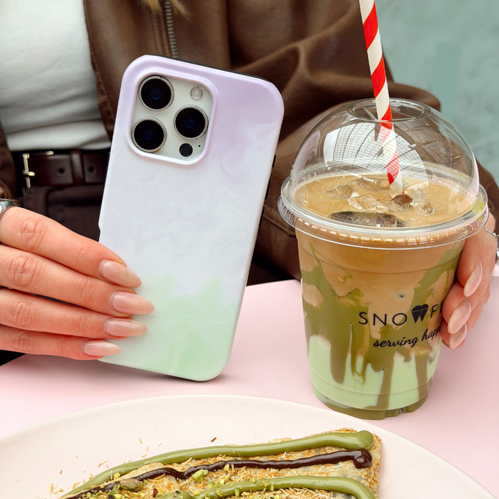 Girl holding the Lavender Matcha Tough Phone Case and a matcha in hand