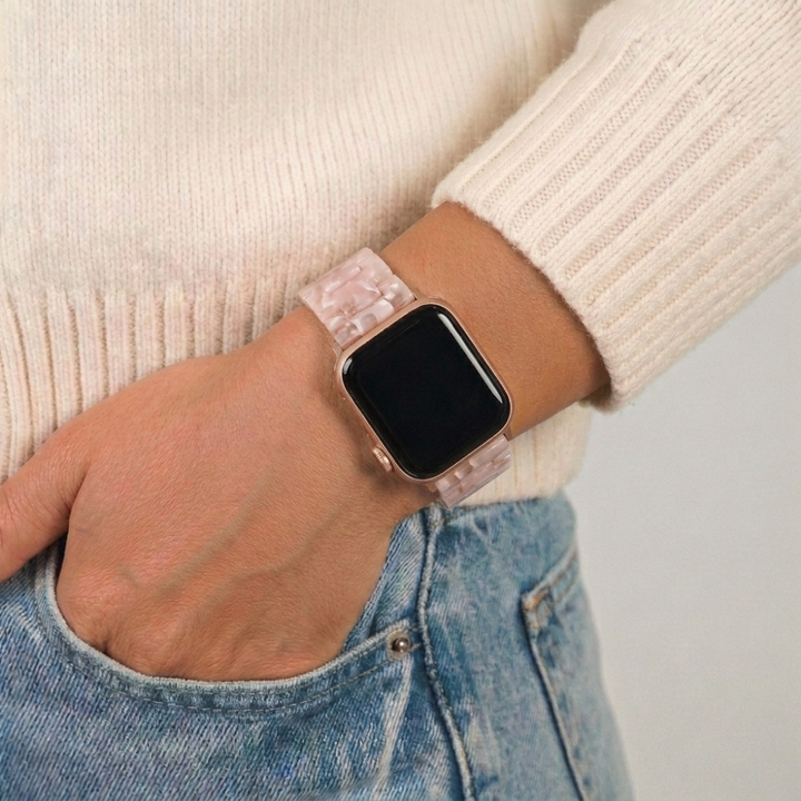 Girl with hand in blue jean pocket wearing luxe pink clouds watch strap