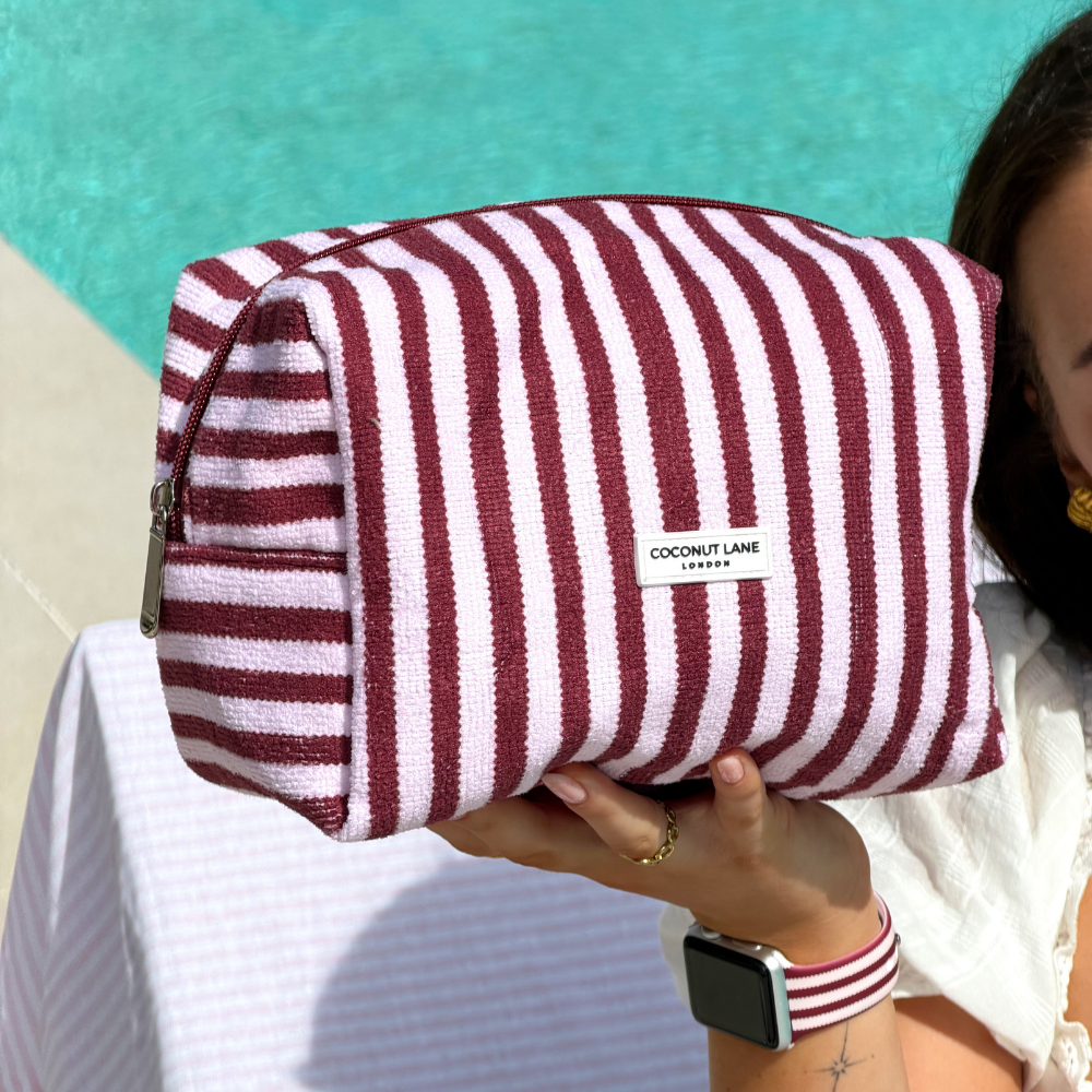 Girl by pool holding her Blushberry Scallop Stripes Towel Makeup Bag
