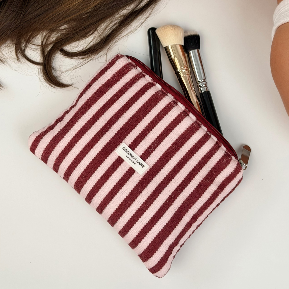 Mini towel everything pouch blushberry stripes on floor with makeup falling out