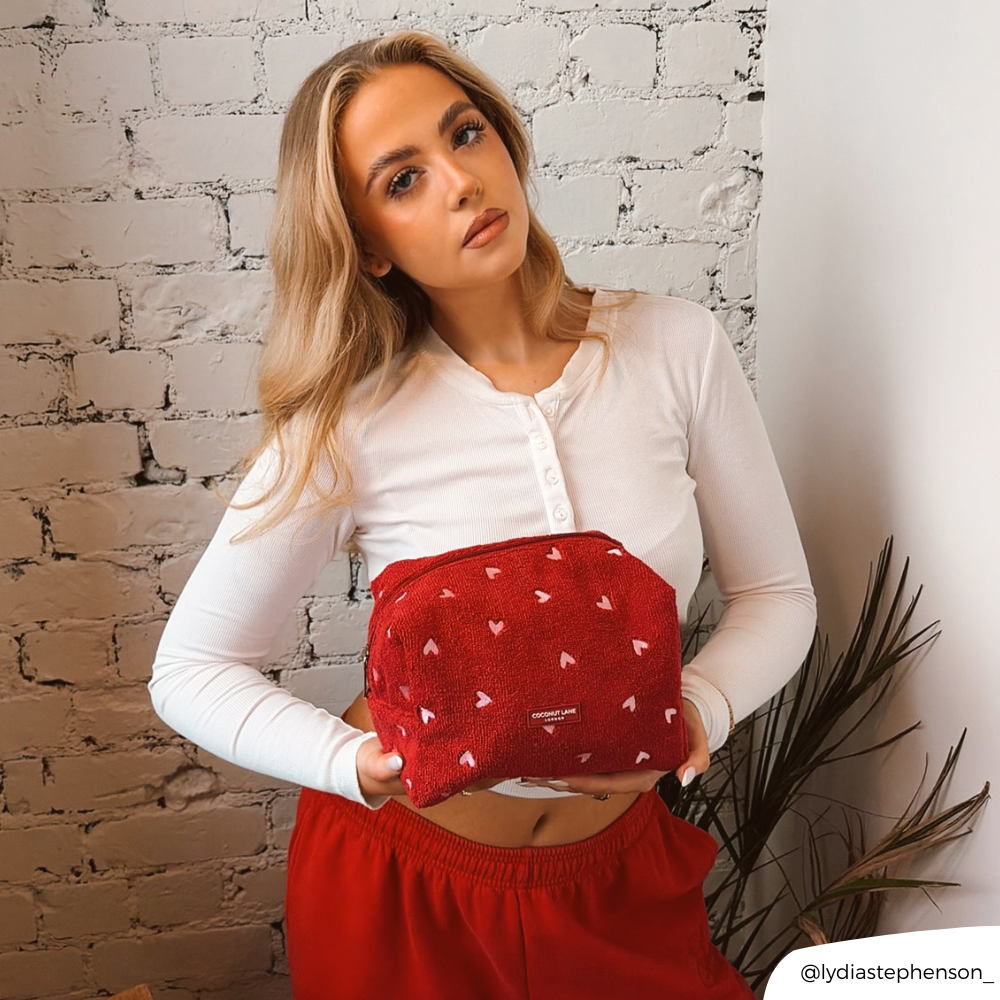 Girl in cafe holding her Mulberry Heart Makeup Bag