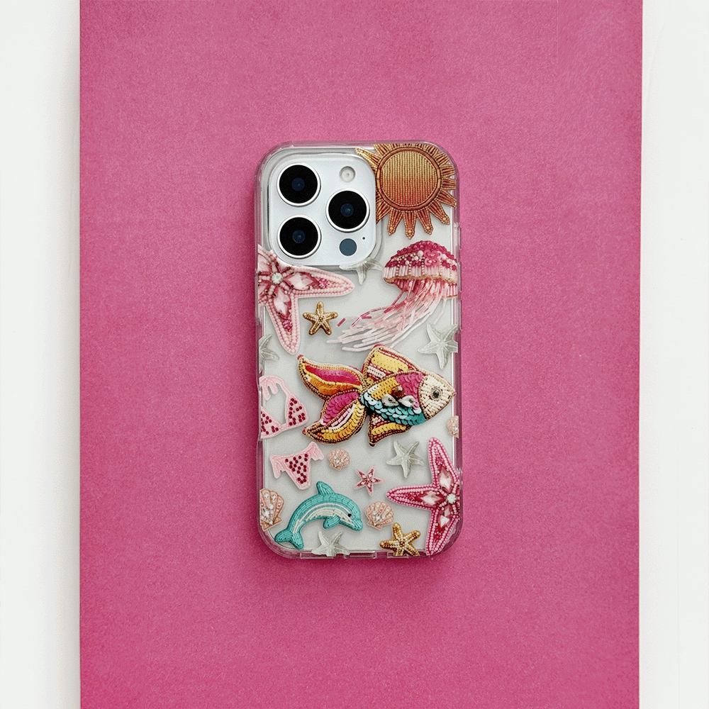 Clear phone case with pink accents, embroidered sea creatures, and sun design from Coconut Lane.