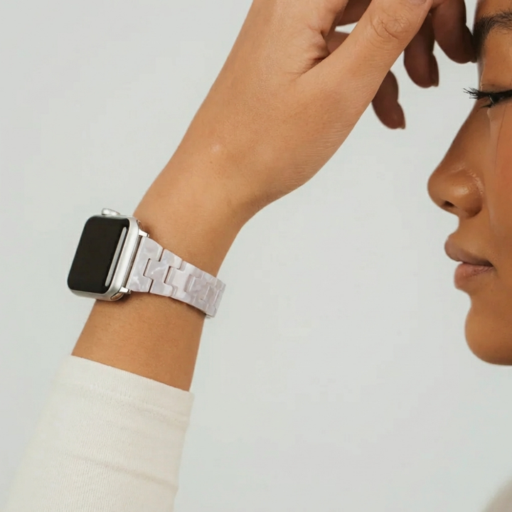 Girl holding up wrist wearing cream long sleeve top showing off Slim Luxe Pearl Watch Strap on her wrist