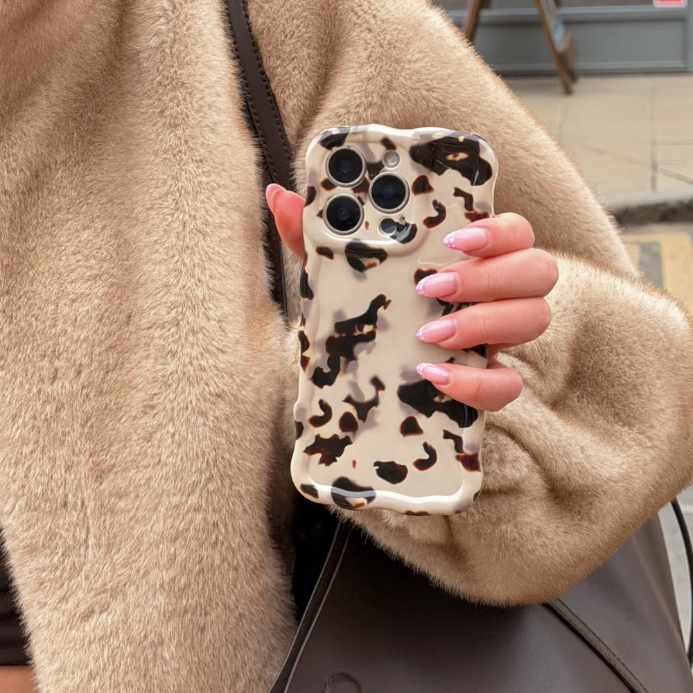 Wavy Ivory Tort Phone Case being held in a lifestyle setting