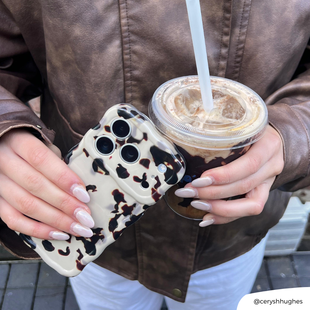 Girl holding iced coffee and Wavy Ivory Tort Phone Case in hand