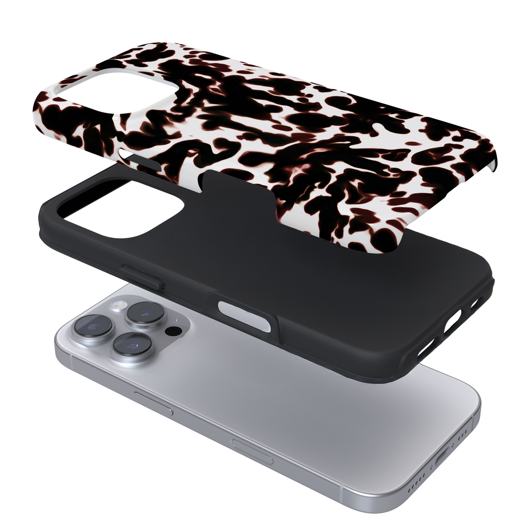 Expanded view of a phone case with a white and black tortoiseshell print on a white background