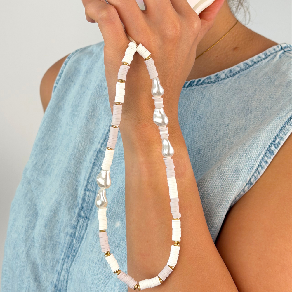 Close up of the beaded nude and pearl phone strap in studio shoot
