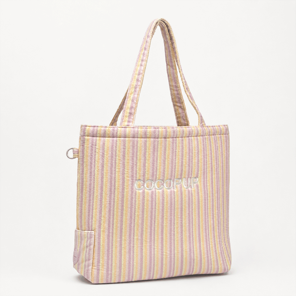 Pastel striped tote bag with a towel-like texture and soft colors.