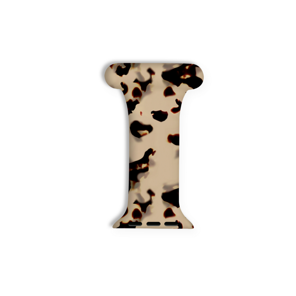 A small, milky ivory object shaped like the letter "I" with rounded ends, featuring a black and brown tortoiseshell pattern. The object, resembling an Apple Watch Clip-on Fob Strap by Coconut Lane, often seen on healthcare professionals, appears to be a connector piece or clip set against a plain white background.