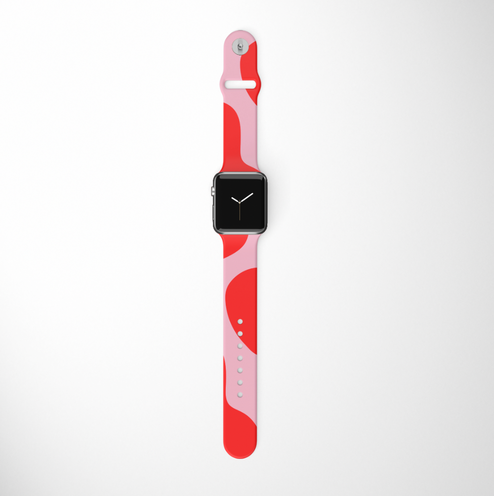 A Coconut Lane smartwatch comes with an Abstract Pink & Red Apple Watch Strap, showcasing a vibrant mix of pink and red tones against a white background. The watch face is black with straightforward white hands for a minimalistic look, and the band includes multiple adjustment holes along with a silver clasp.